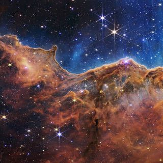 NASA’s Webb Reveals Cosmic Cliffs, Glittering Landscape of Star Birth