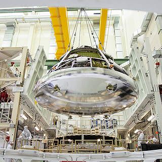 photo of the Orion crew module for Artemis 1 being lifted by a crane 